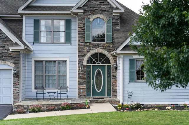 a front view of a house with garden
