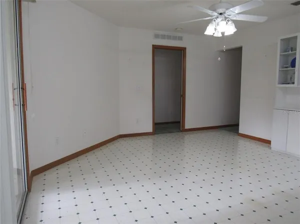 a view of a livingroom with a ceiling fan and window