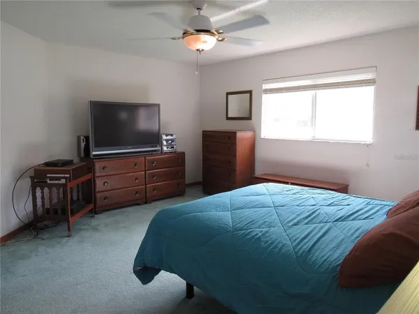 a bedroom with a bed and flat screen tv