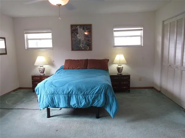 a bedroom with a bed and a lamp