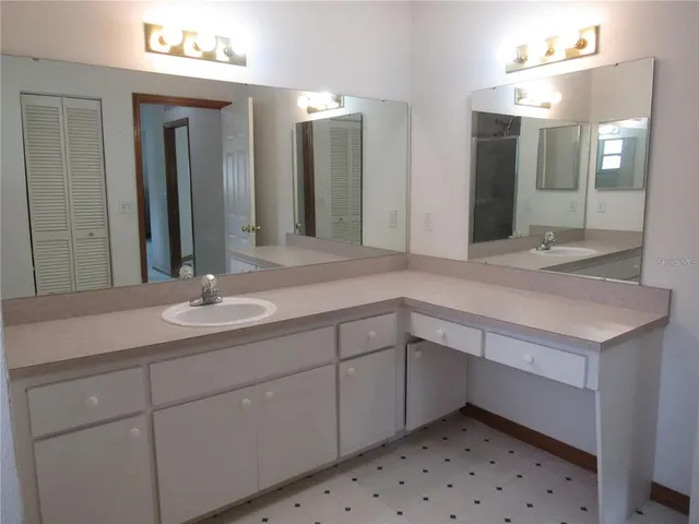 a bathroom with a sink double vanity and a mirror