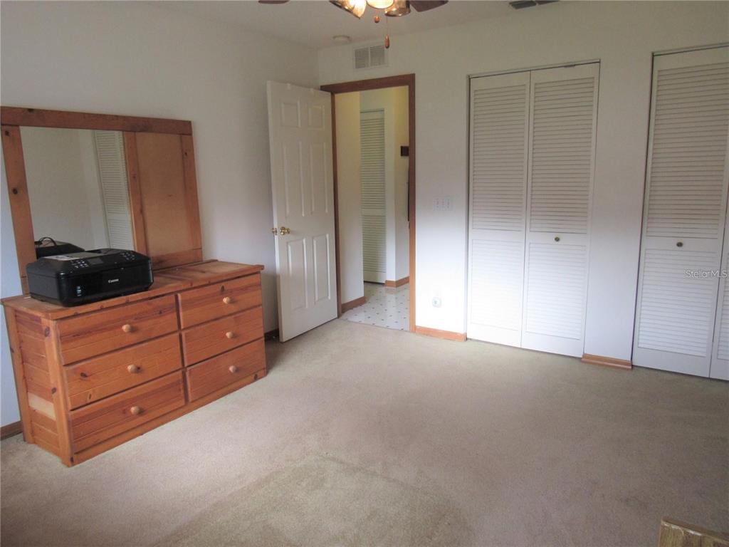 9002 Southwest 96th Lane, Unit C Ocala, FL 34481 - Photo 20 of 28 a room with a dresser and a window