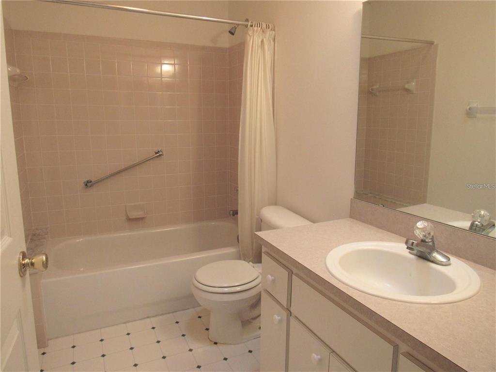 9002 Southwest 96th Lane, Unit C Ocala, FL 34481 - Photo 22 of 28 a bathroom with a sink toilet and shower