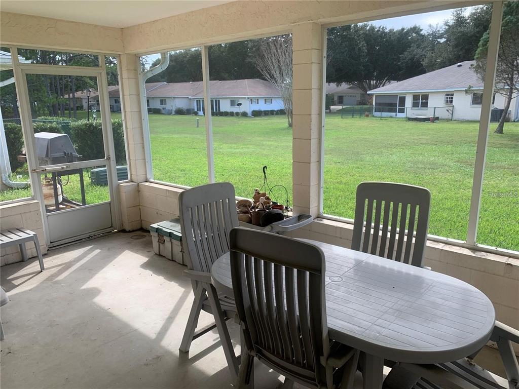 9002 Southwest 96th Lane, Unit C Ocala, FL 34481 - Photo 28 of 28 a view of a patio with table and chairs