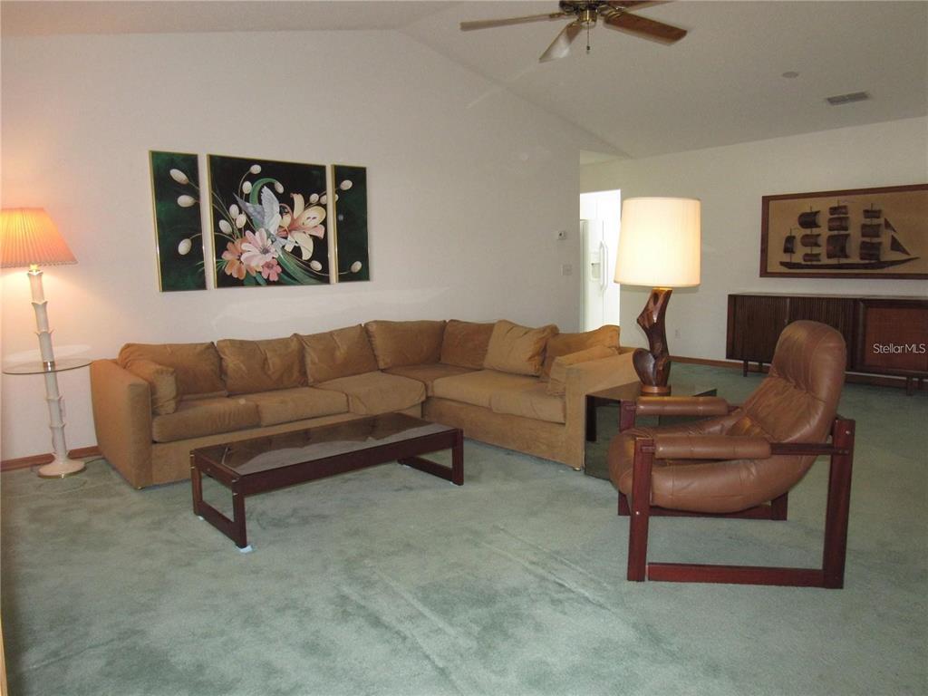 9002 Southwest 96th Lane, Unit C Ocala, FL 34481 - Photo 5 of 28 a living room with furniture and a window