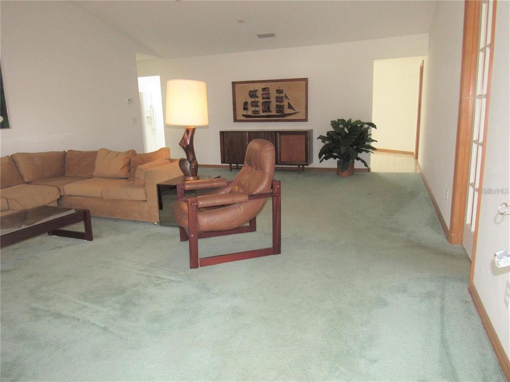 9002 Southwest 96th Lane, Unit C Ocala, FL 34481 - Photo 8 of 28 a living room with furniture and a window