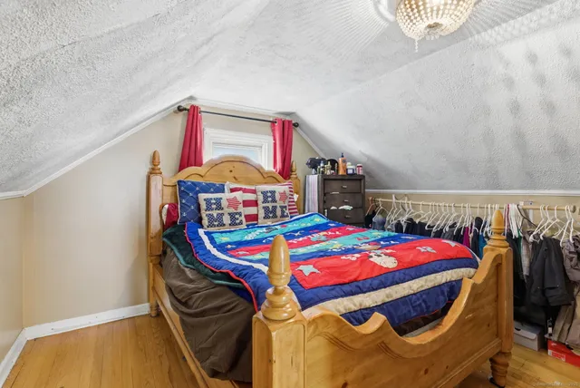 a bedroom with a bed a dresser and a book shelf