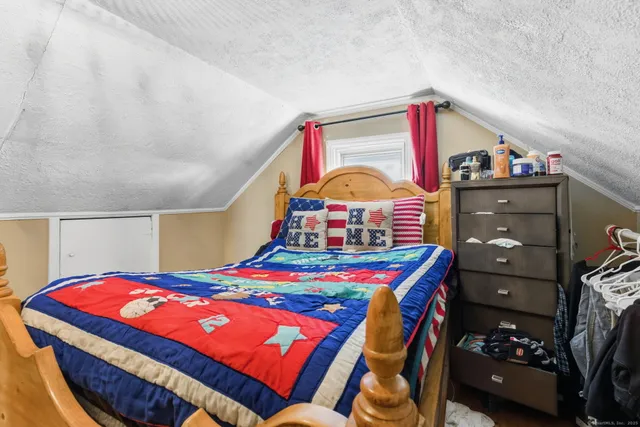 a bedroom with a bed and dresser