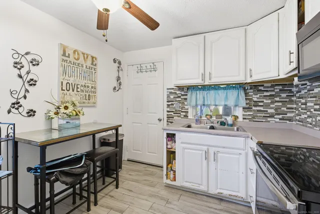 a kitchen with stainless steel appliances kitchen island granite countertop a sink and cabinets