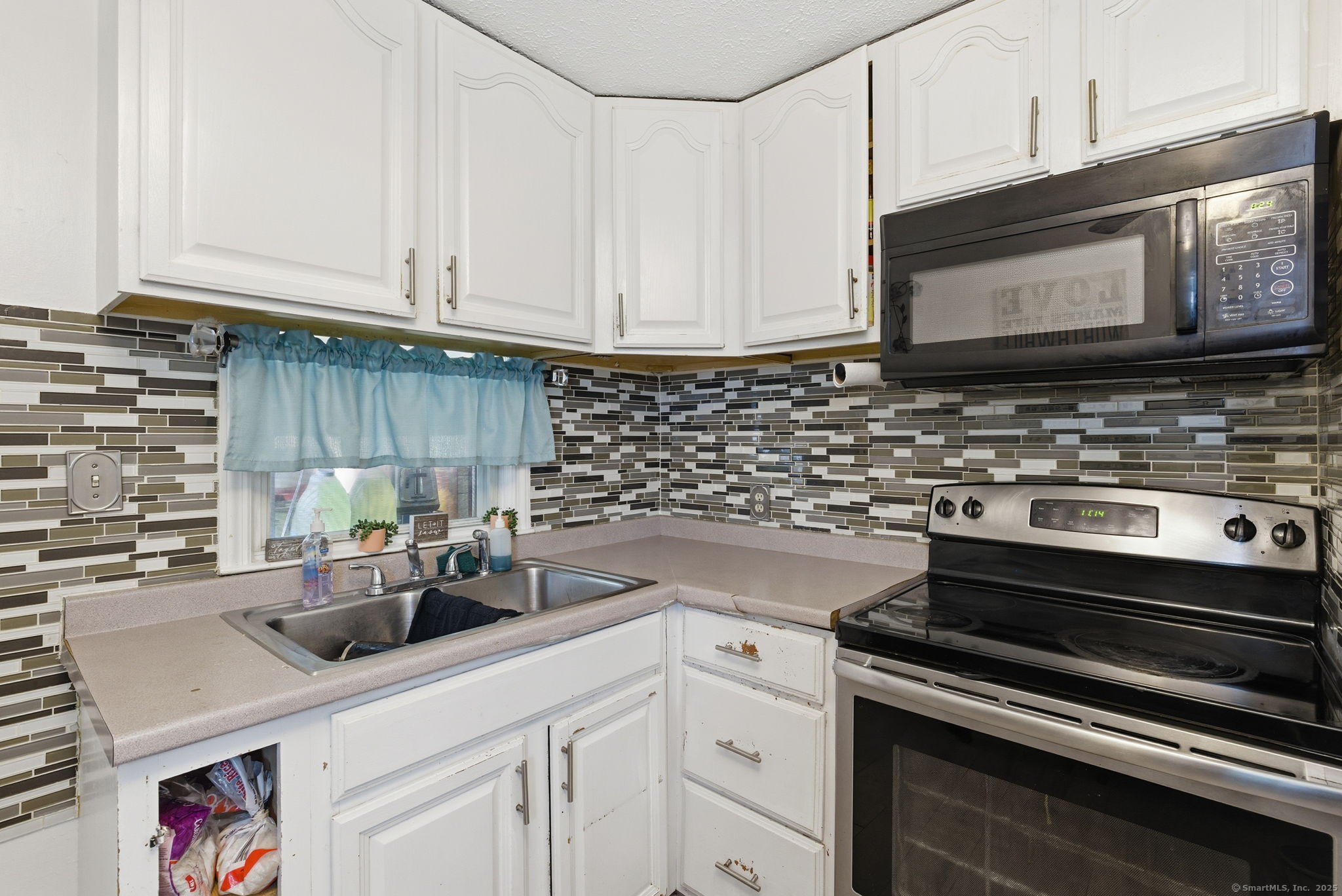 55 Alexander Road New Britain, CT 06053 - Photo 20 of 38 a kitchen with stainless steel appliances white cabinets and a stove top oven