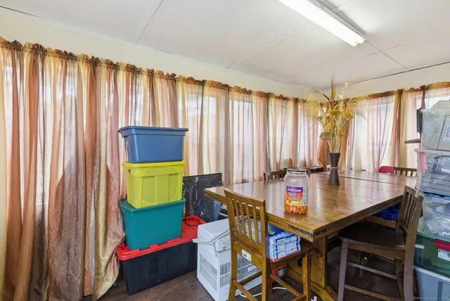 a view of a dining room with furniture and window