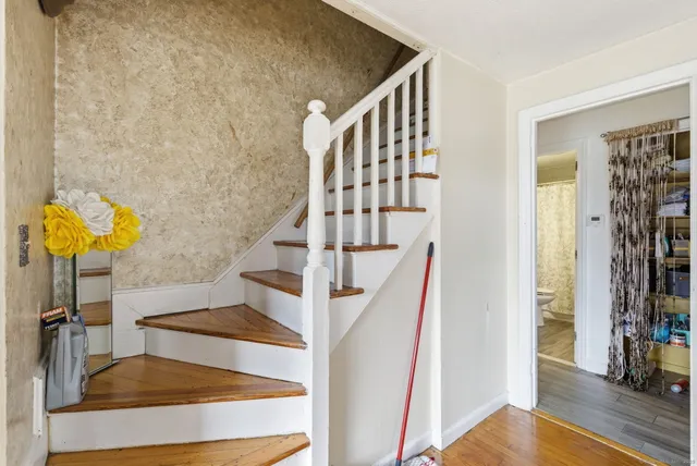a view of entryway and hall with wooden floor