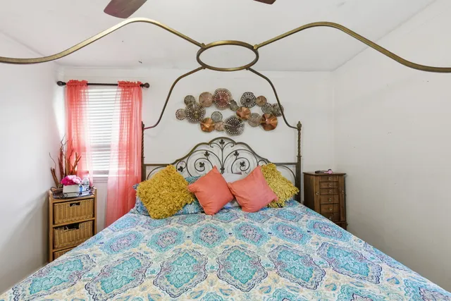 a bedroom with a bed and a painting on the wall