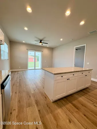 a view of a room with wooden floor