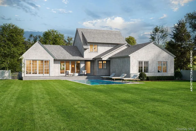 a front view of a house with swimming pool having outdoor seating