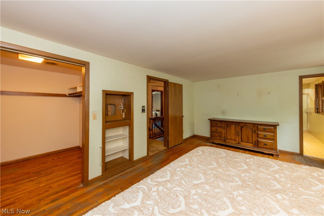 25001 Letchworth Road Beachwood, OH 44122 - Photo 25 of 50 Hardwood flooring throughout the room, complemented by a built-in closet with shelving and an additional built-in alcove with shelving