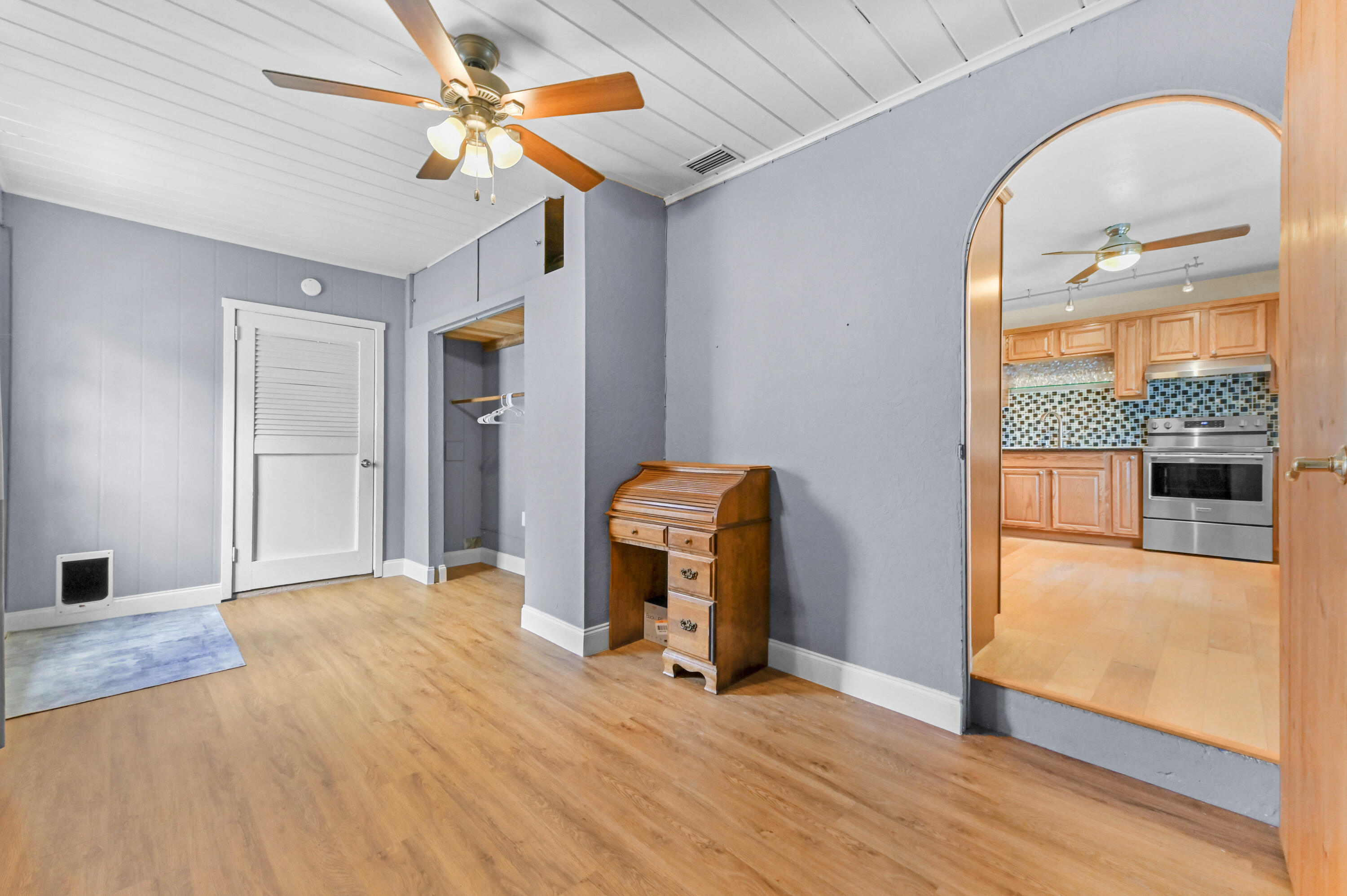 5709 Southeast Indigo Avenue Stuart, FL 34997 - Photo 10 of 26 wooden floor in an empty room with a window
