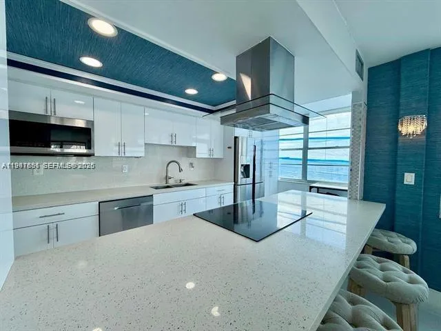 a kitchen with stainless steel appliances granite countertop a sink a stove and cabinets