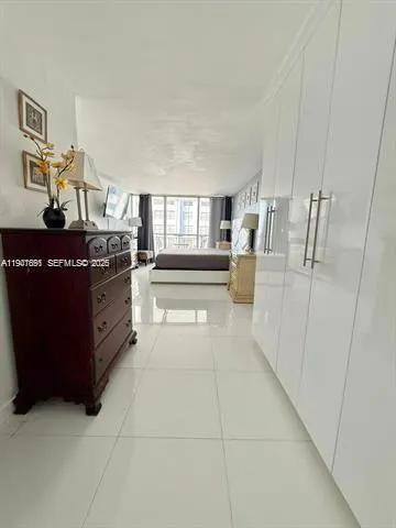 a view of kitchen with stainless steel appliances granite countertop a refrigerator and a stove