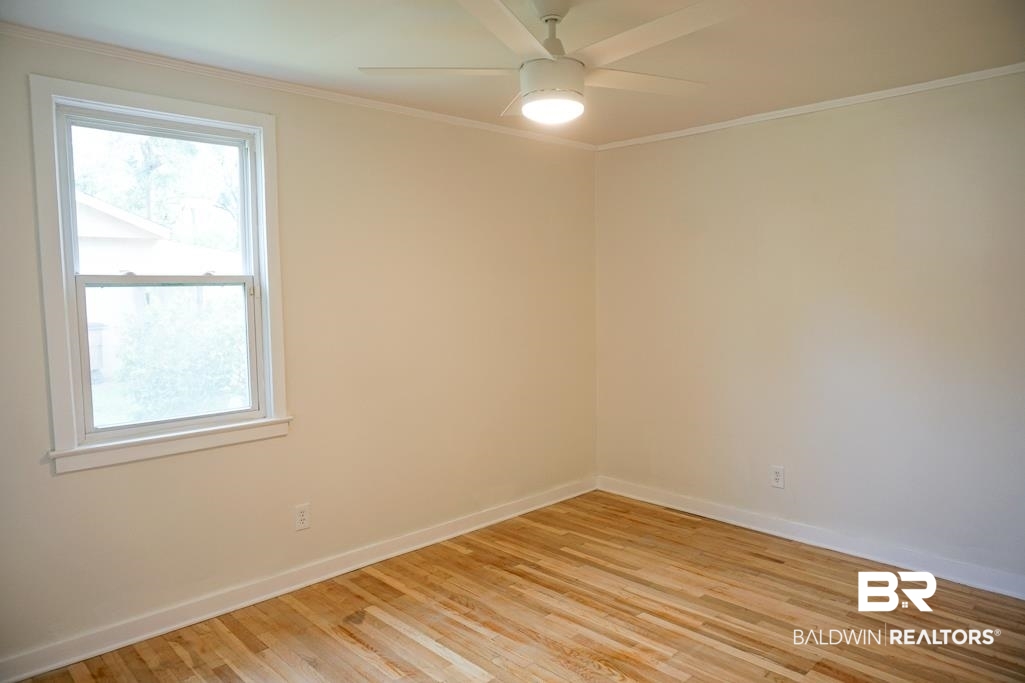 4667 Cottonwood Drive Mobile, AL 36608 - Photo 19 of 21 Empty room with ceiling fan, light hardwood / wood-style flooring, and ornamental molding