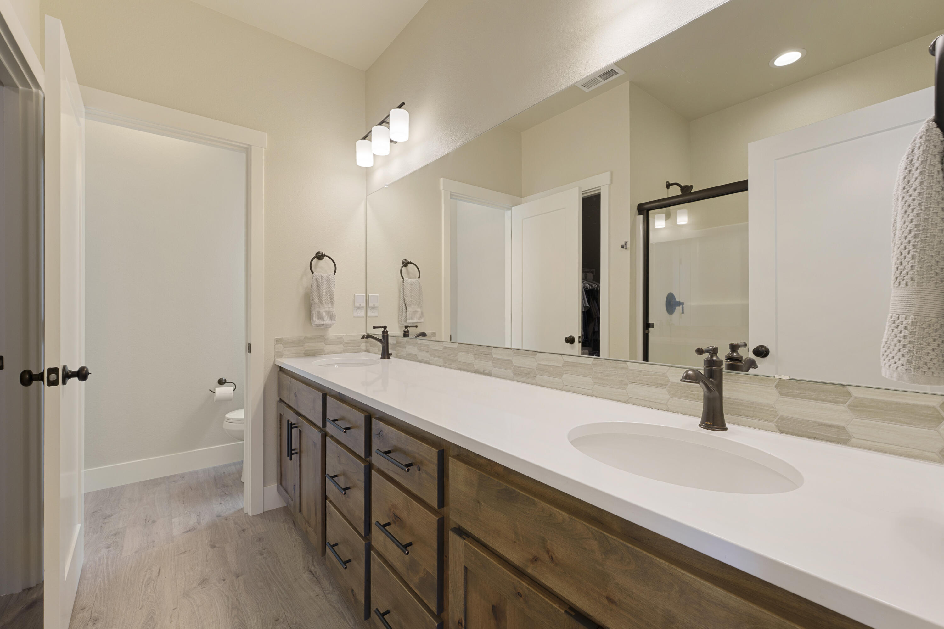 4999 Southwest Yew Place Redmond, OR 97756 - Photo 23 of 50 a bathroom with a double vanity sink and a mirror