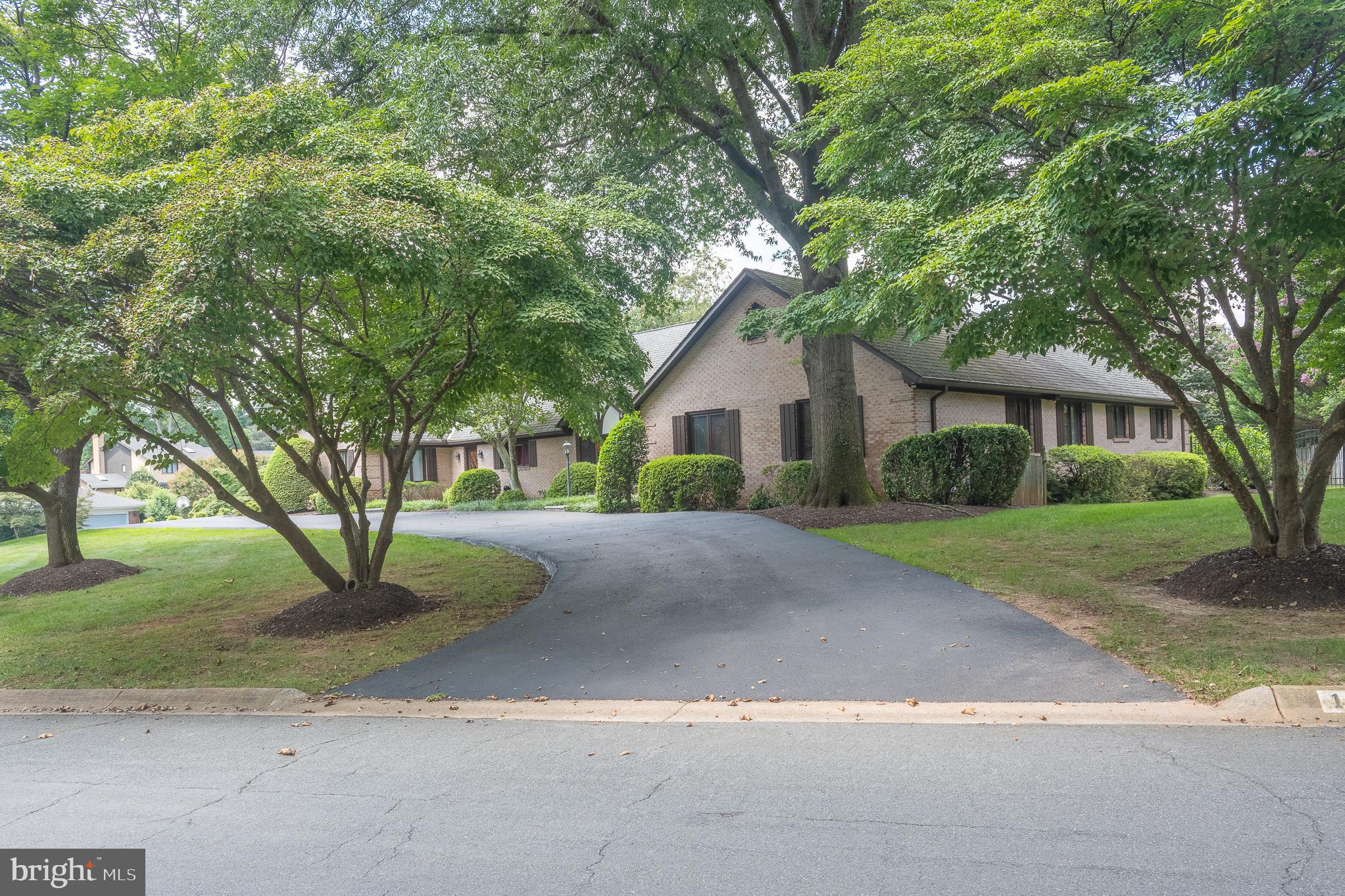 11301 Crossing Glen Court Potomac, MD 20854 - Photo 115 of 136 a front view of a house with a yard and garage