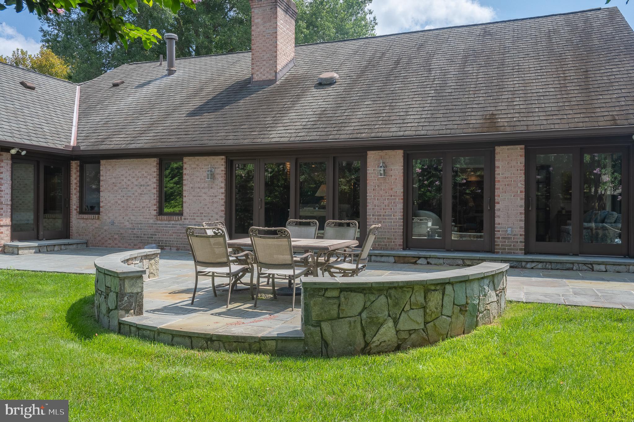11301 Crossing Glen Court Potomac, MD 20854 - Photo 125 of 136 a view of a patio with table and chairs potted plants and floor to ceiling window
