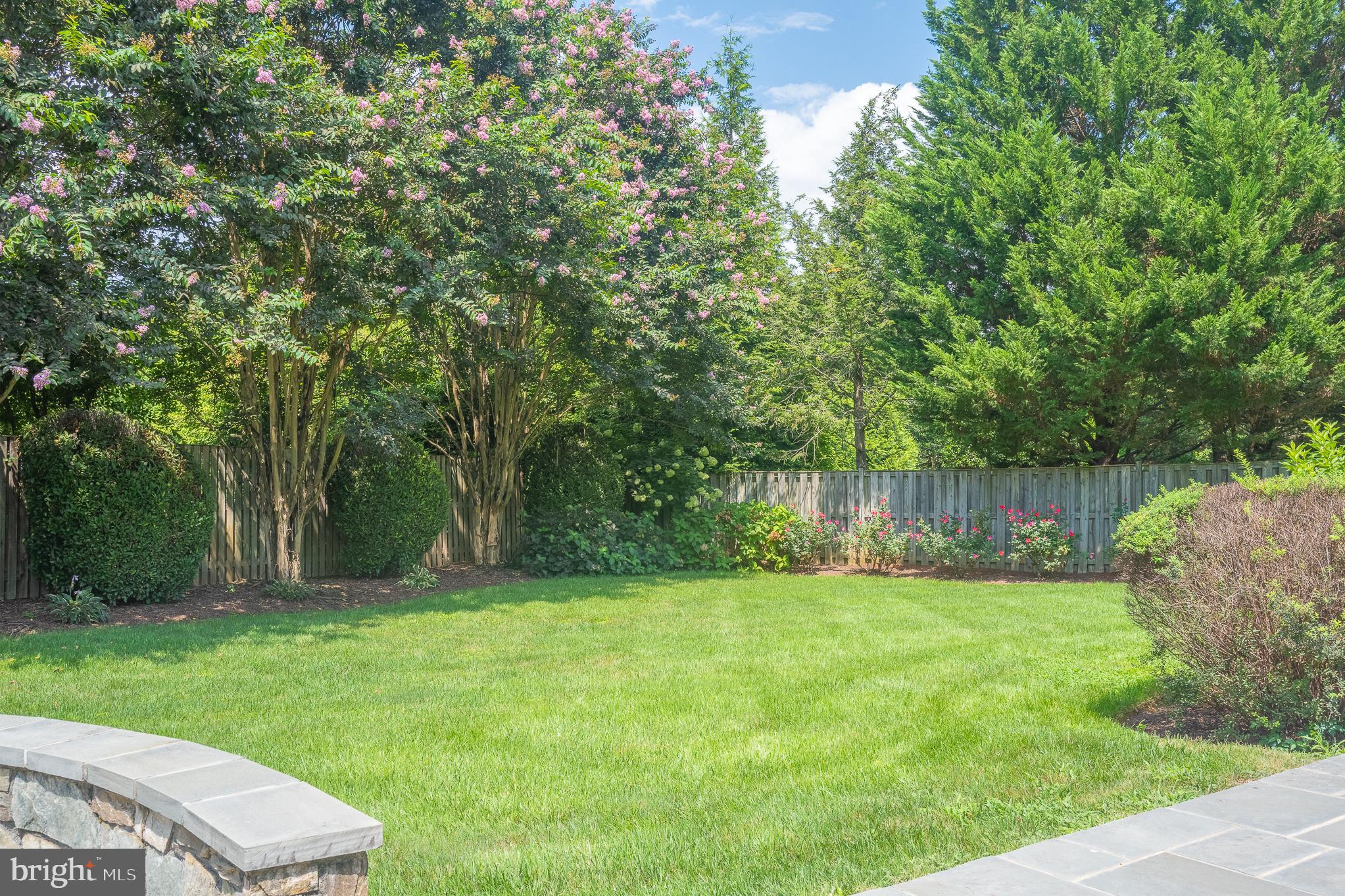 11301 Crossing Glen Court Potomac, MD 20854 - Photo 130 of 136 a backyard of a house with lots of plants and large tree
