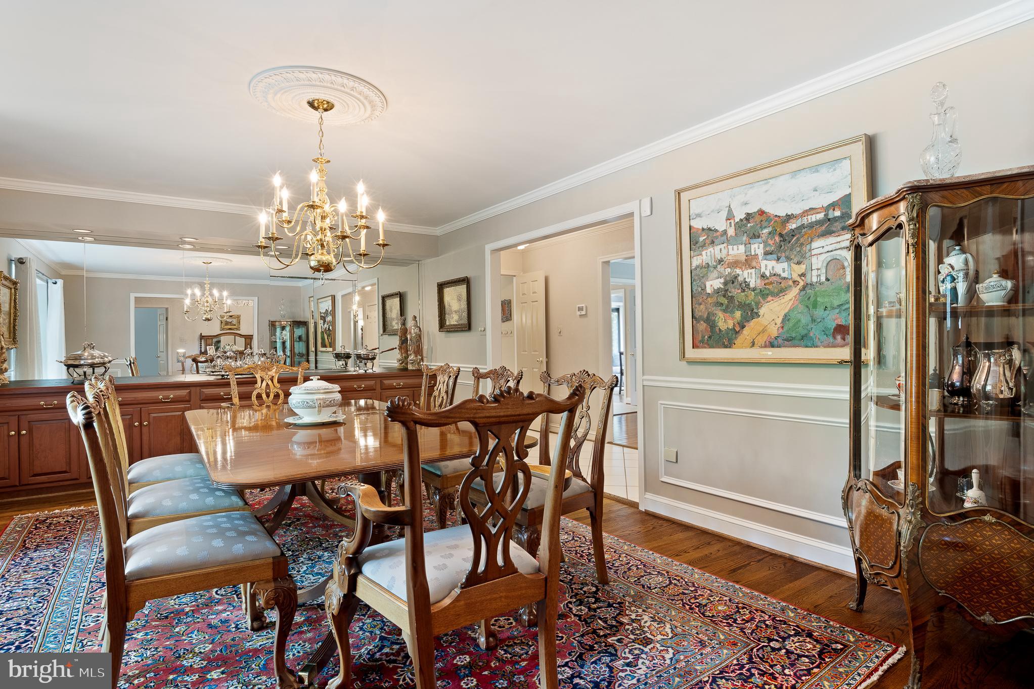 11301 Crossing Glen Court Potomac, MD 20854 - Photo 13 of 136 a view of a dining room with furniture a chandelier and wooden floor