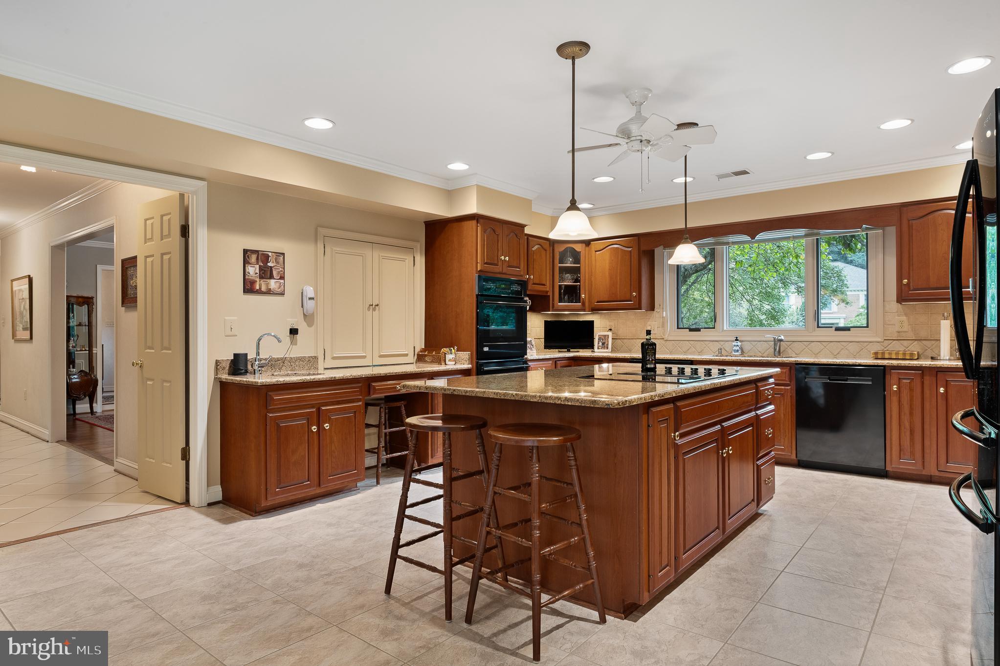 11301 Crossing Glen Court Potomac, MD 20854 - Photo 39 of 136 a kitchen with a sink a counter top space appliances and cabinets