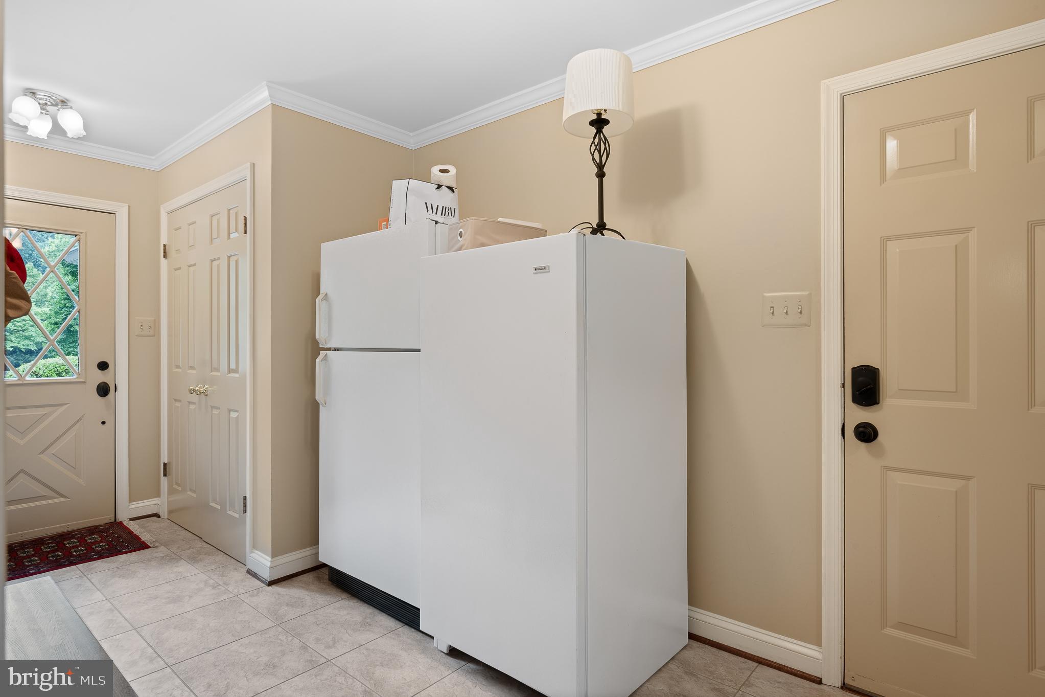 11301 Crossing Glen Court Potomac, MD 20854 - Photo 47 of 136 a white refrigerator freezer sitting inside of a kitchen