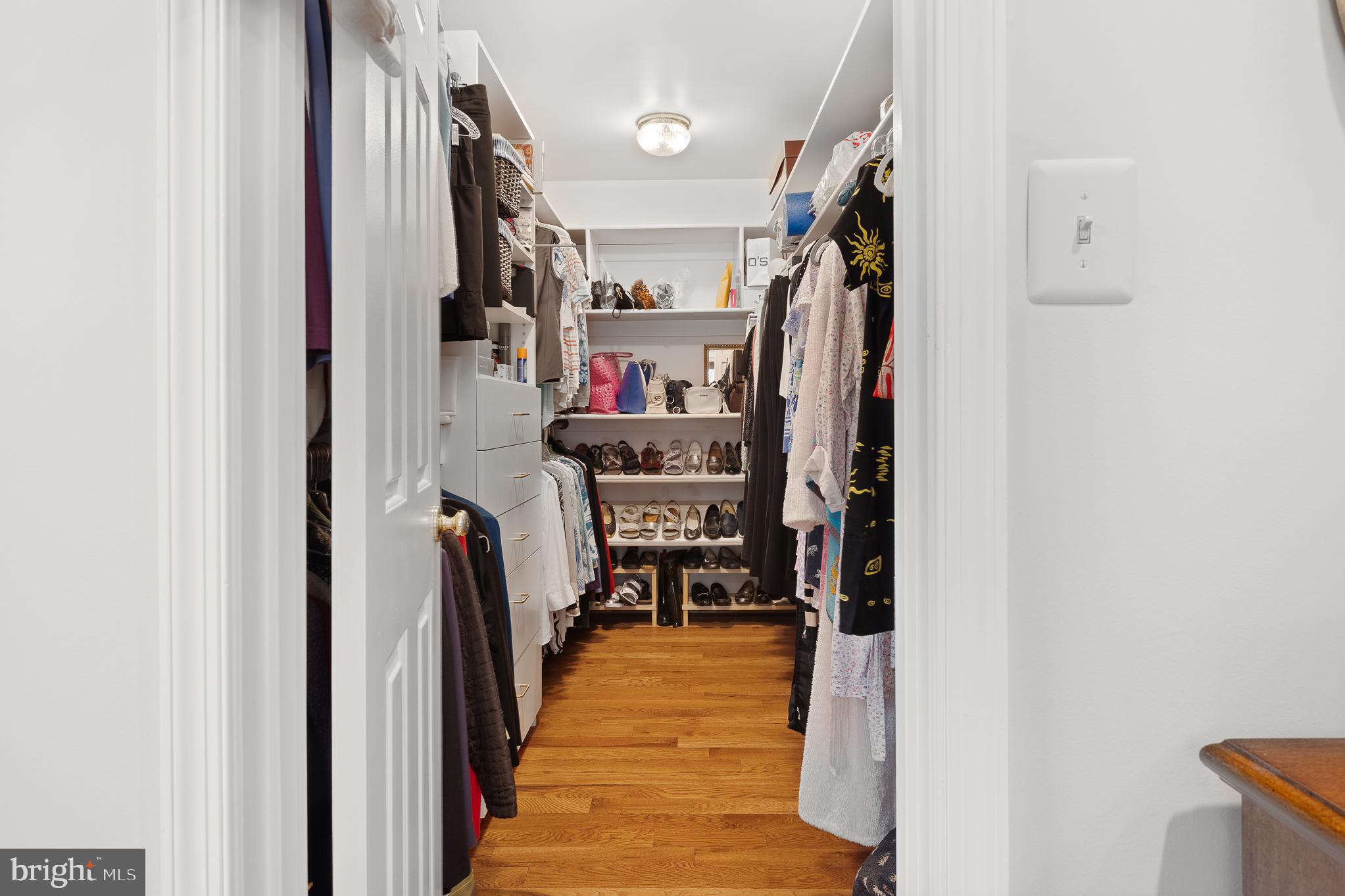 11301 Crossing Glen Court Potomac, MD 20854 - Photo 74 of 136 a view of walk in closet with clothes and shoes