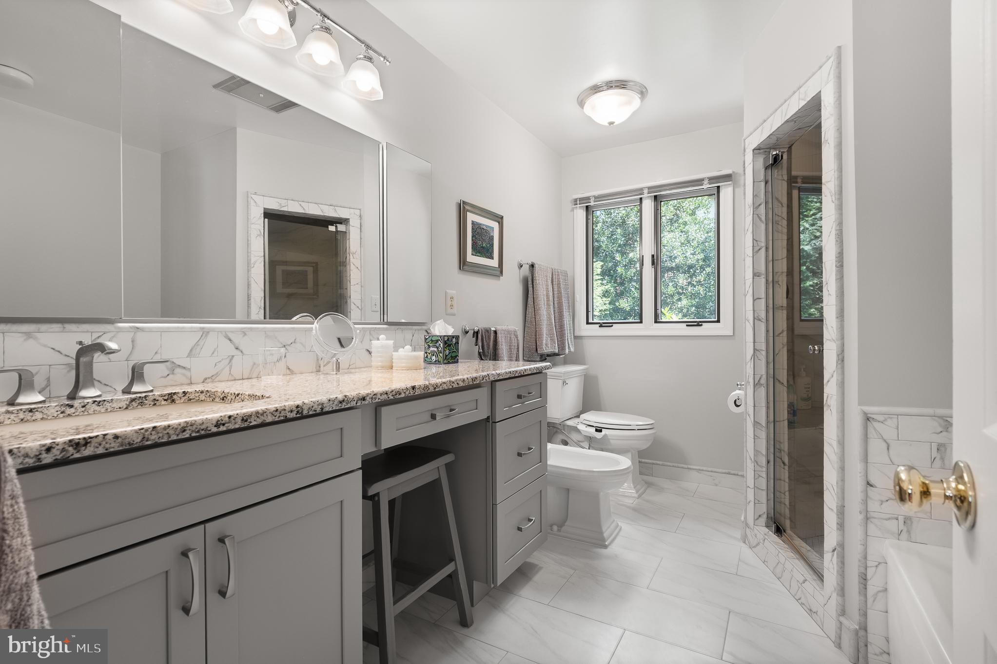 11301 Crossing Glen Court Potomac, MD 20854 - Photo 77 of 136 a bathroom with a granite countertop sink a toilet and a mirror