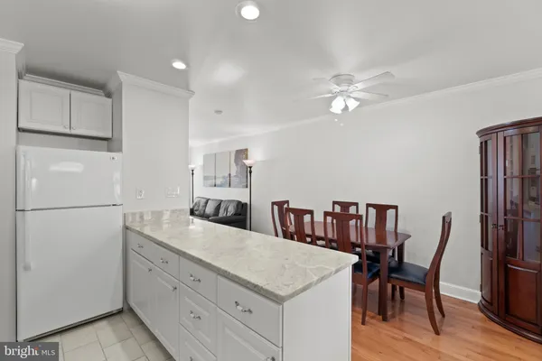 a kitchen with refrigerator cabinets and wooden floor
