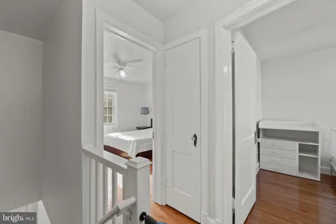 a view of a hallway with wooden floor and entryway