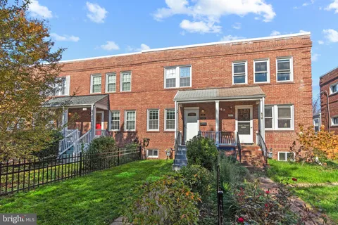 front view of a brick house with a large windows