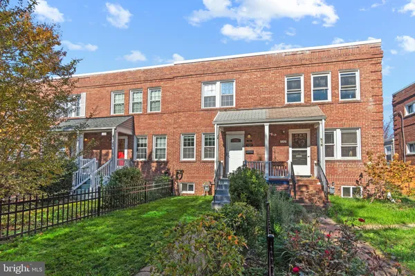 front view of a brick house with a large windows