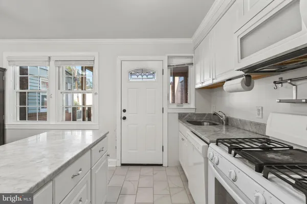 a kitchen with stainless steel appliances granite countertop a sink stove and cabinets