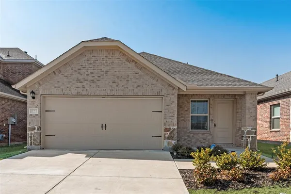 a front view of a house with garage