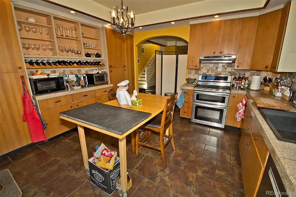 a kitchen with stainless steel appliances a stove a sink and a refrigerator