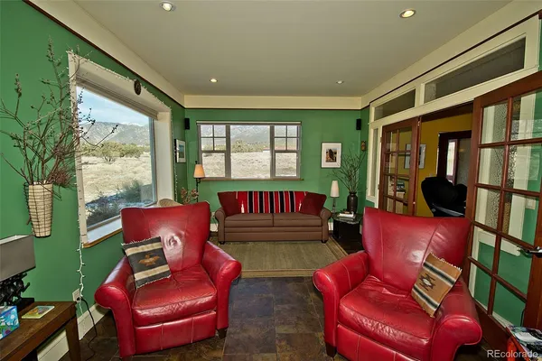 a living room with furniture a rug and a large window