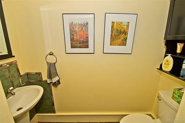 a bathroom with a sink mirror and toilet