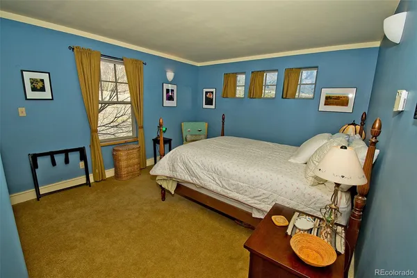 a bed sitting in a bedroom next to a window