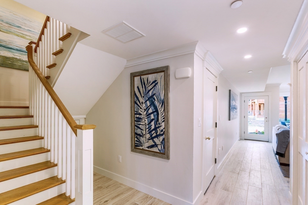 163 Atlantic Road, Unit 10 Gloucester, MA 01930 - Photo 12 of 23 a view of a hallway with wooden floor and entryway