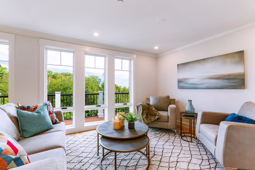 163 Atlantic Road, Unit 10 Gloucester, MA 01930 - Photo 6 of 23 a living room with furniture and a large window