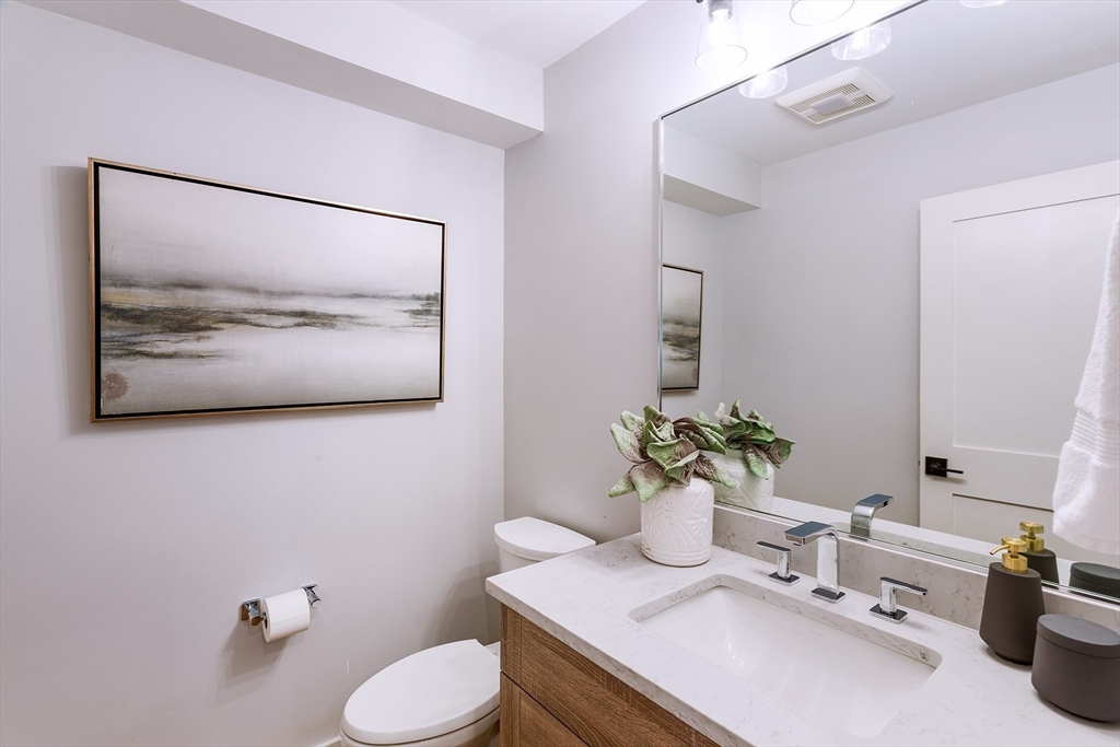 163 Atlantic Road, Unit 10 Gloucester, MA 01930 - Photo 8 of 23 a bathroom with a sink mirror and toilet