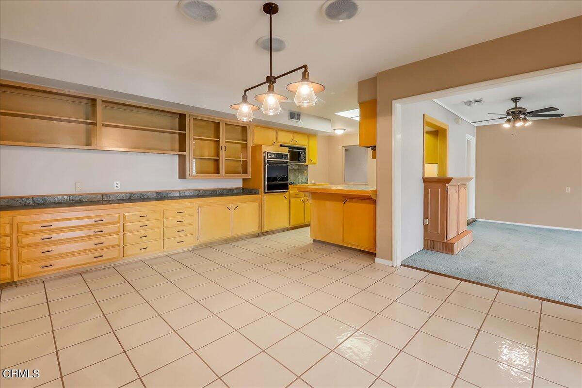 26204 Ridgemoor Road Menifee, CA 92586 - Photo 14 of 35 a view of a kitchen with cabinet and windows