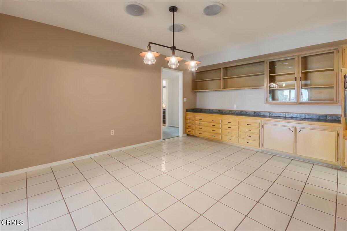 26204 Ridgemoor Road Menifee, CA 92586 - Photo 15 of 35 a view of a kitchen with kitchen island granite countertop cabinets and chandelier