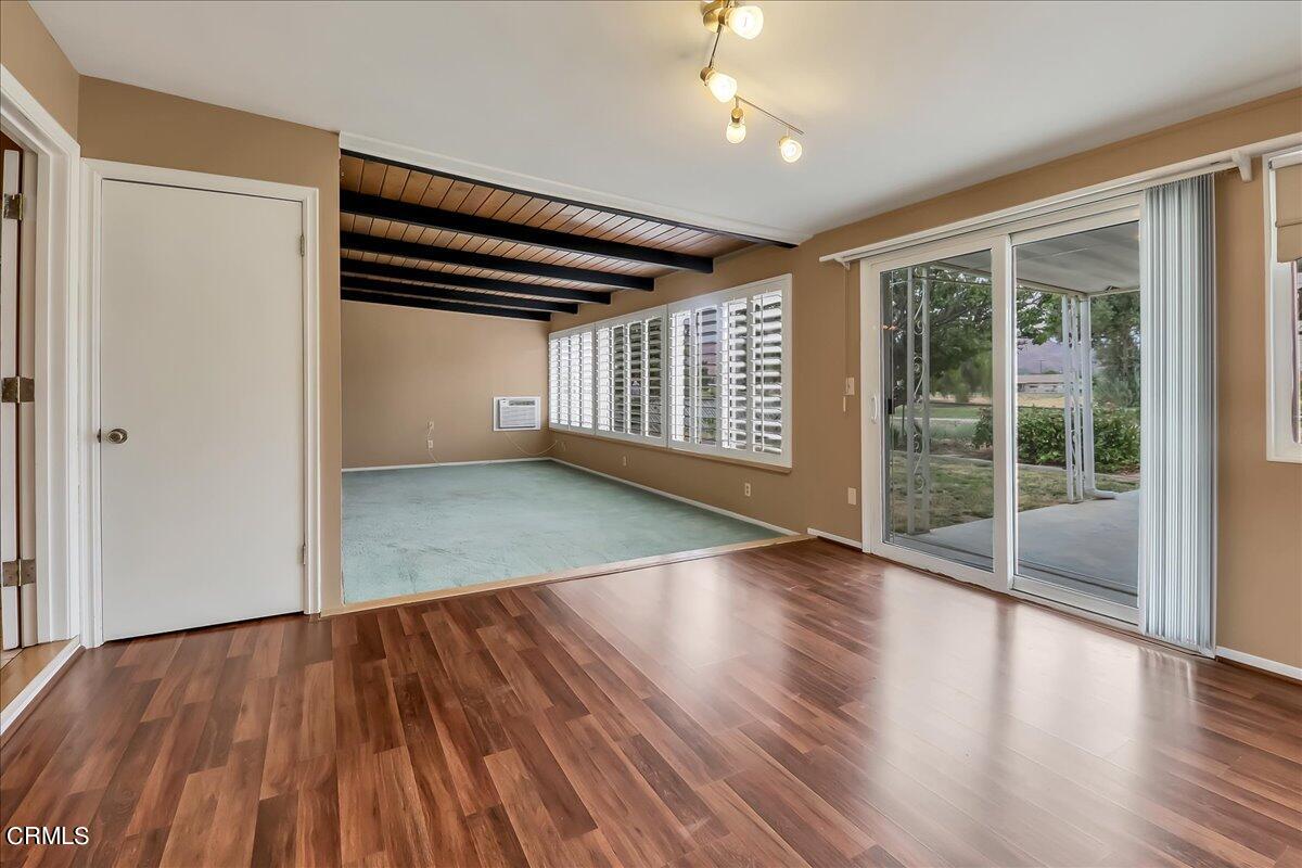 26204 Ridgemoor Road Menifee, CA 92586 - Photo 17 of 35 an empty room with wooden floor and windows
