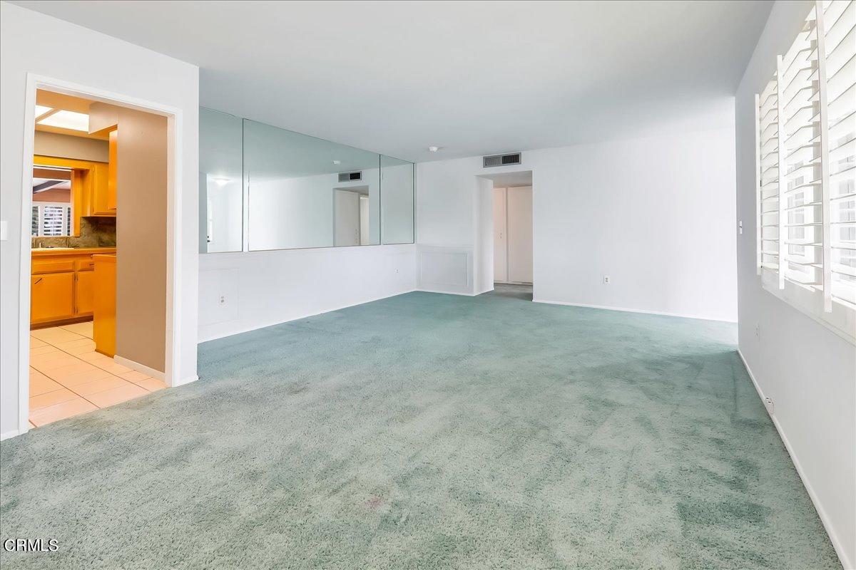 26204 Ridgemoor Road Menifee, CA 92586 - Photo 7 of 35 an empty room with windows and entrance to other room